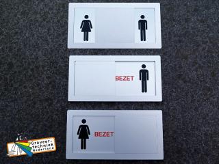 Schuifbord bezet, met picto man en vrouw.